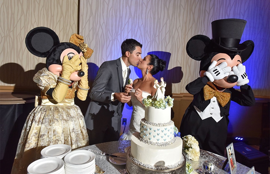 Wedding Couple Kiss as Mickey and Minnie Cover Their Eyes