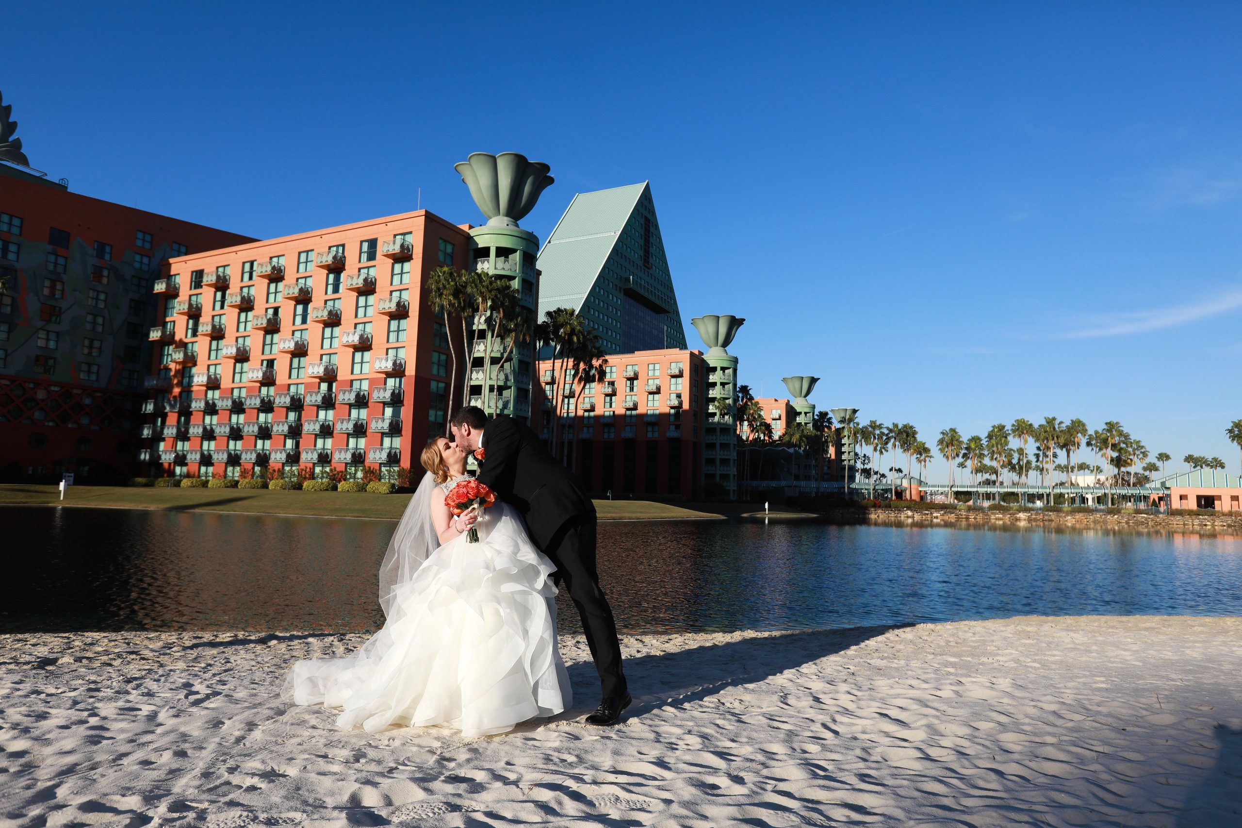 Wedding Couple Kissing on the Beach After Ceremony at the Walt Disney World Dolphin Resort