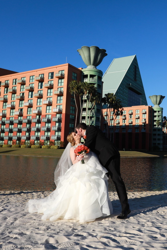 Wedding Couple Kissing on the Beach After Ceremony at the Walt Disney World Dolphin Resort