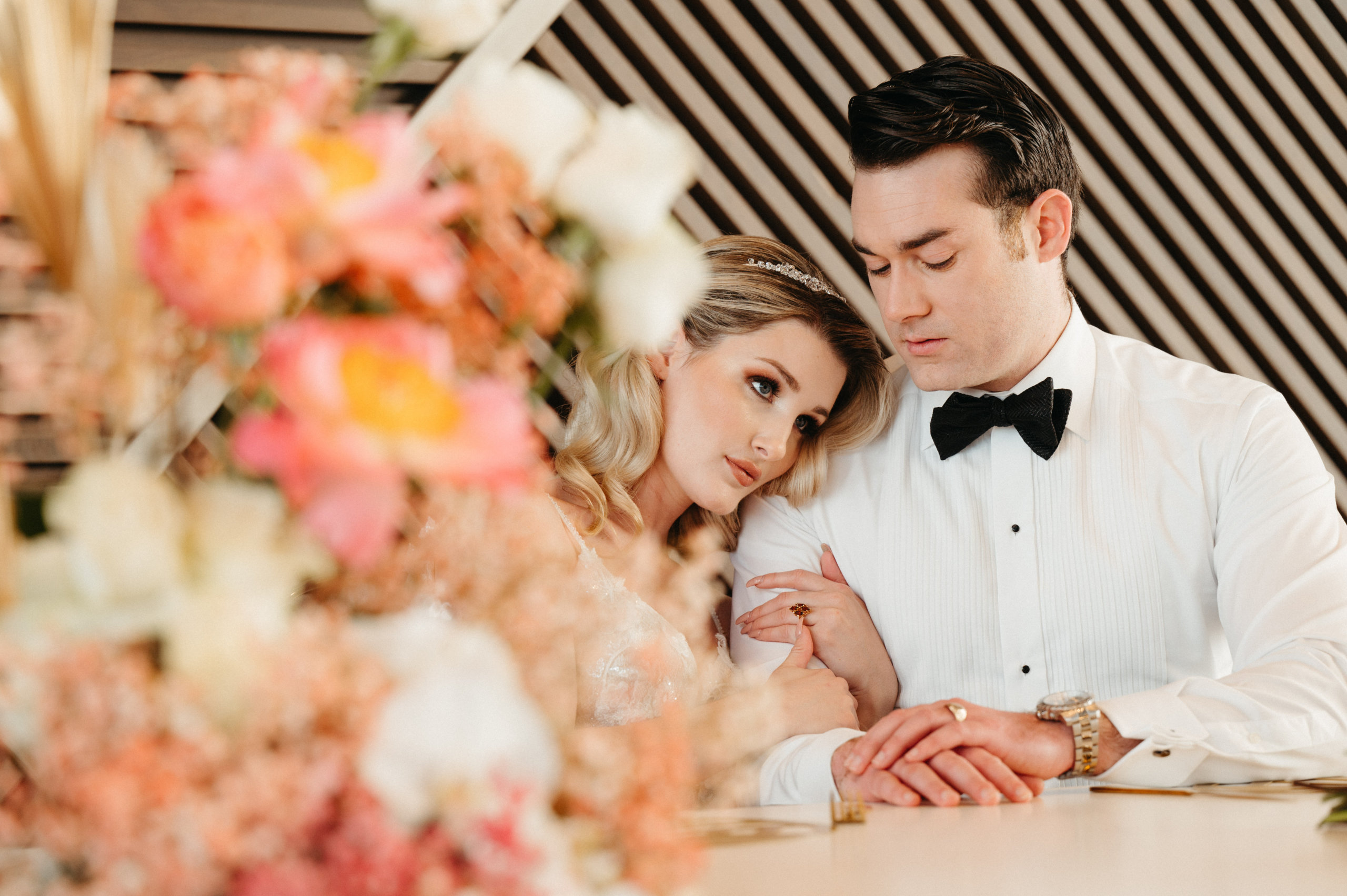 Wedding Couple Sitting at the Vue with Flower Arrangement