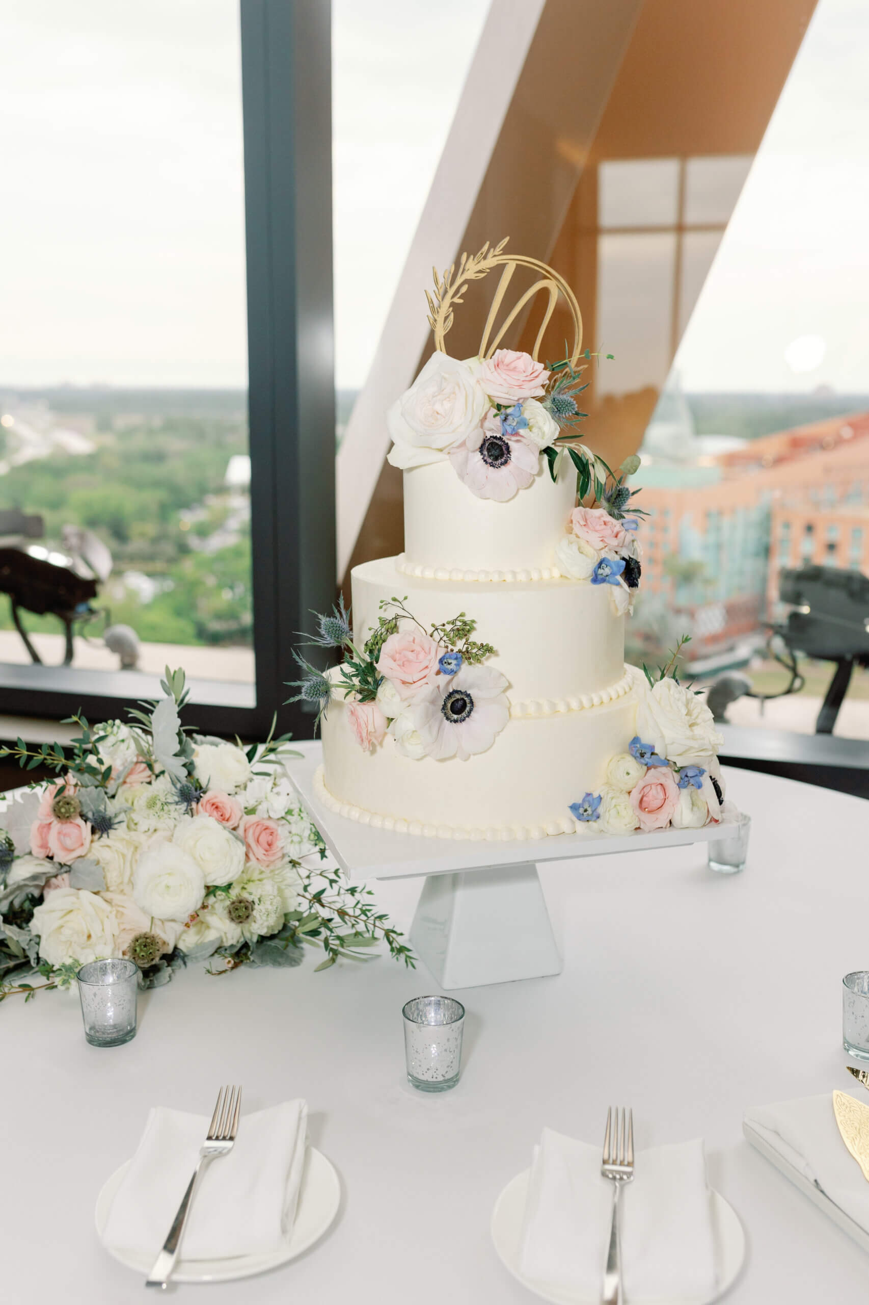 White wedding cake with pretty pastel flowers.
